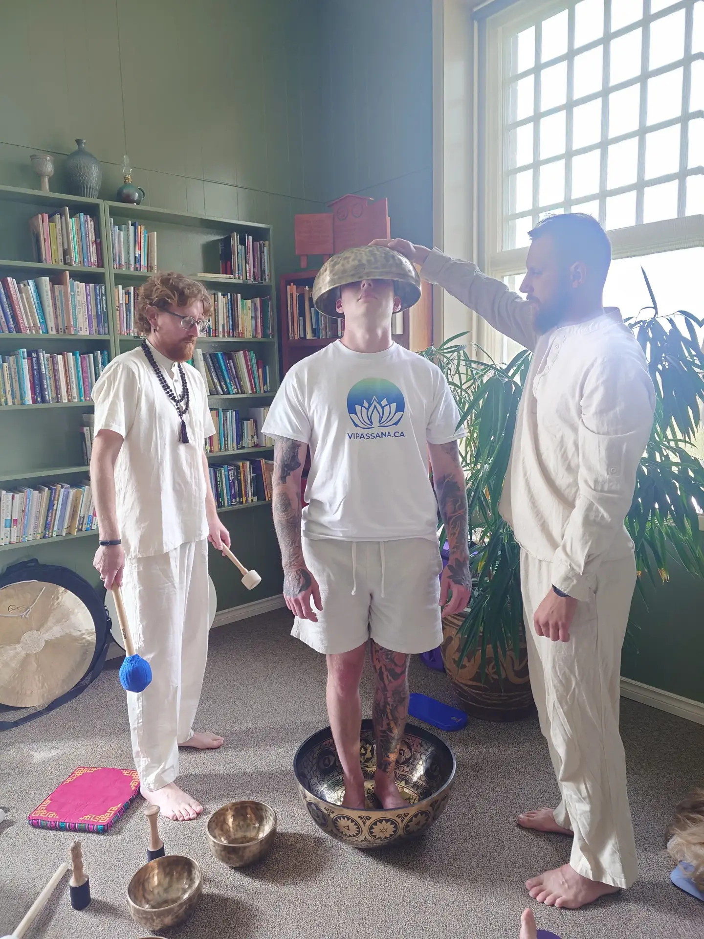Artem Rusinov leading a sound healing journey with Tibetan singing bowls at a Vipassana.ca retreat