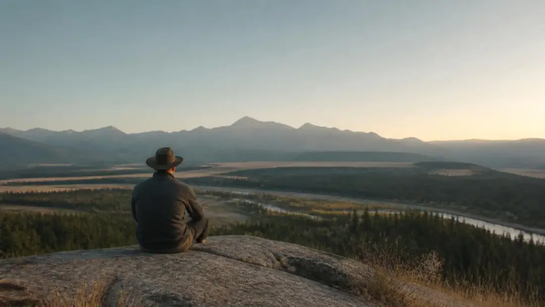 How to stop overthinking: a person sitting quietly outdoors in Alberta looking at an open landscape