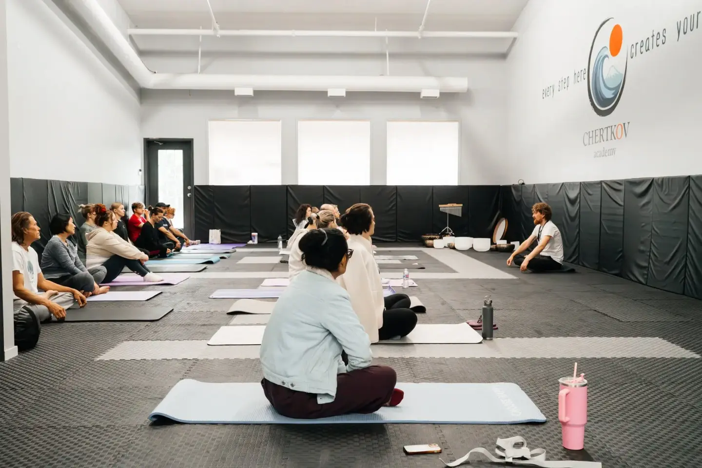 Beginners learning to meditate at a Vipassana.ca session, on mats and cushions